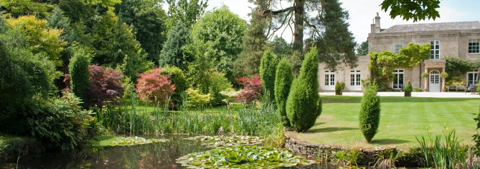 Pond, gardens and main country house at Guyers House Hotel & Restaurant