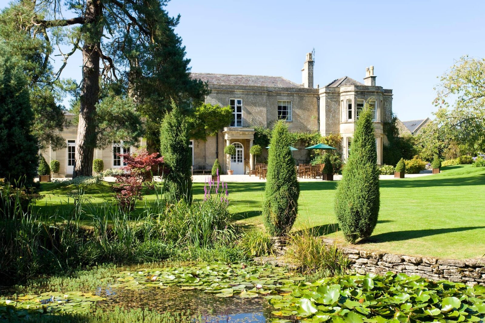 Pond, gardens, outdoor seating areas and main country house at Guyers House Hotel & Restaurant